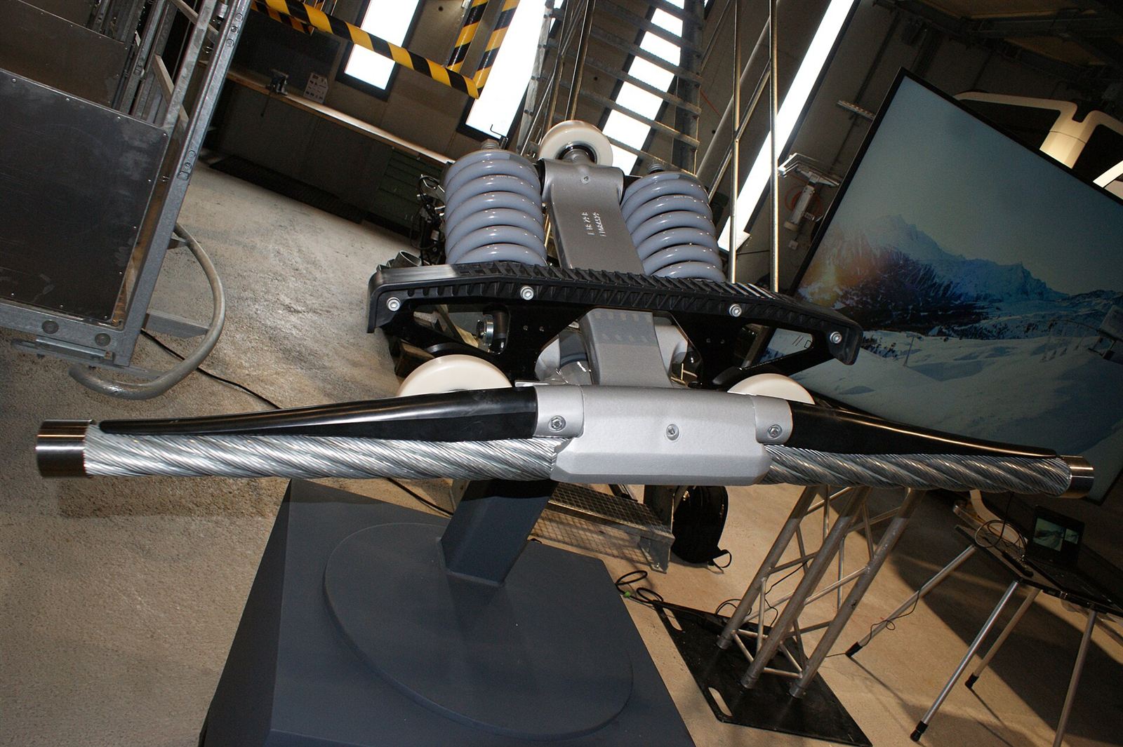 Close-up of a detachable grip: the spring-loaded gripping jaw and the hanger connection