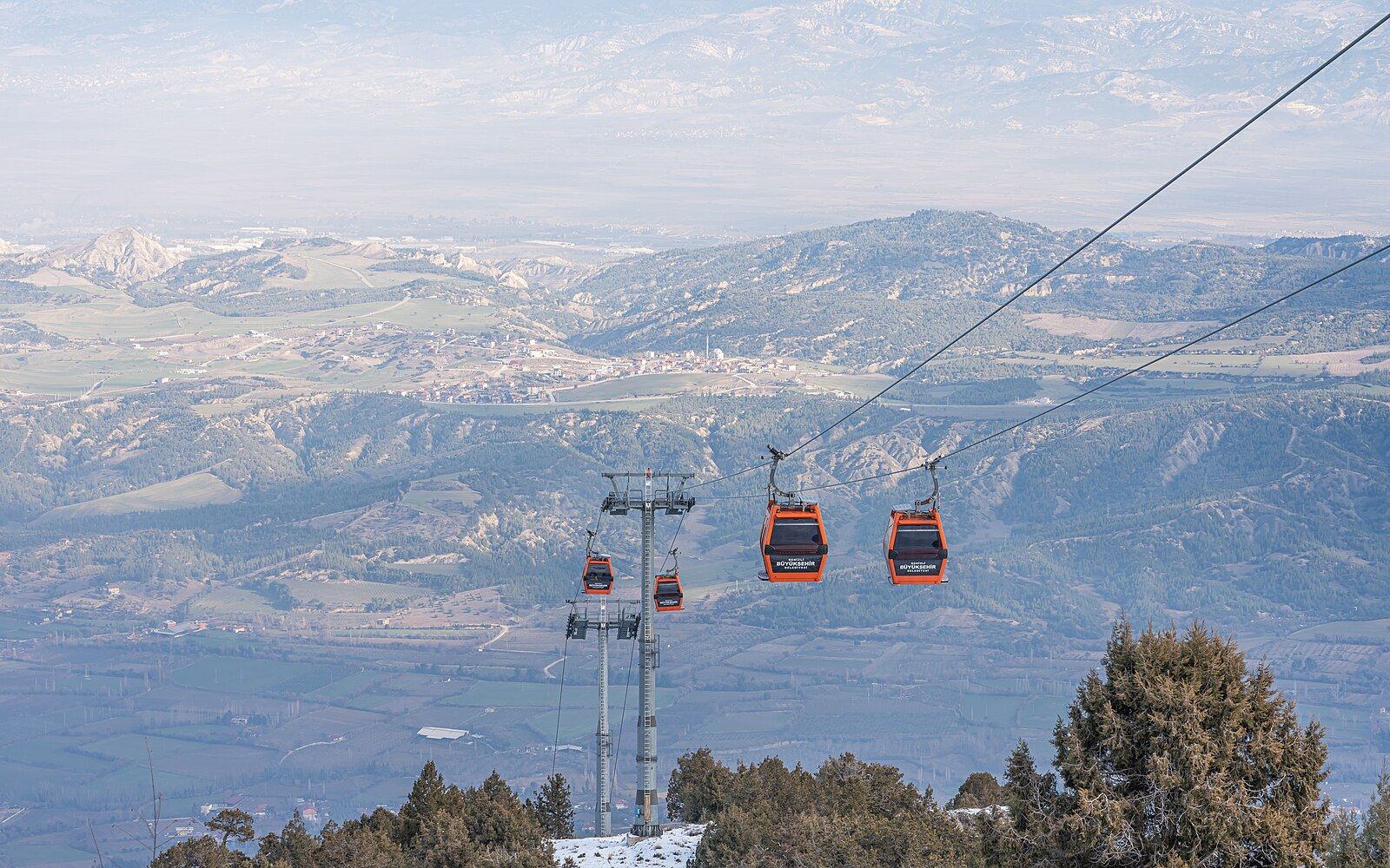 Denizli teleferiğinin kabini üst istasyondan şehir üzerinde ilerlerken